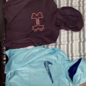 Two sweatshirts one Nike one under armor. Both have a small stain.